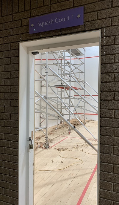 Looking through the door of the former squash court to scaffolding