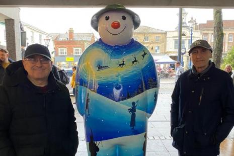 Two local men with dementia with one of the snowman sculptures in Hitchin