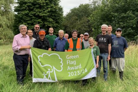 Group of people with a Green Flag in Norton Common nature reserve