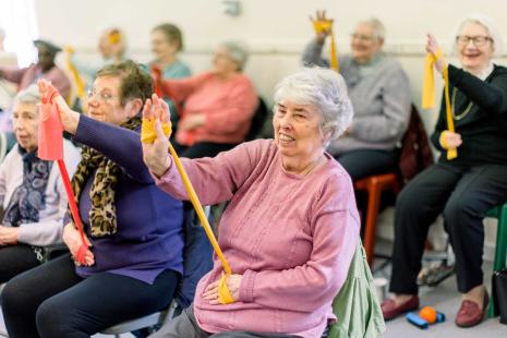 Older people taking part in chair exercises