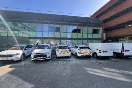 Six council electric vehicles plugged in at the council's staff car park