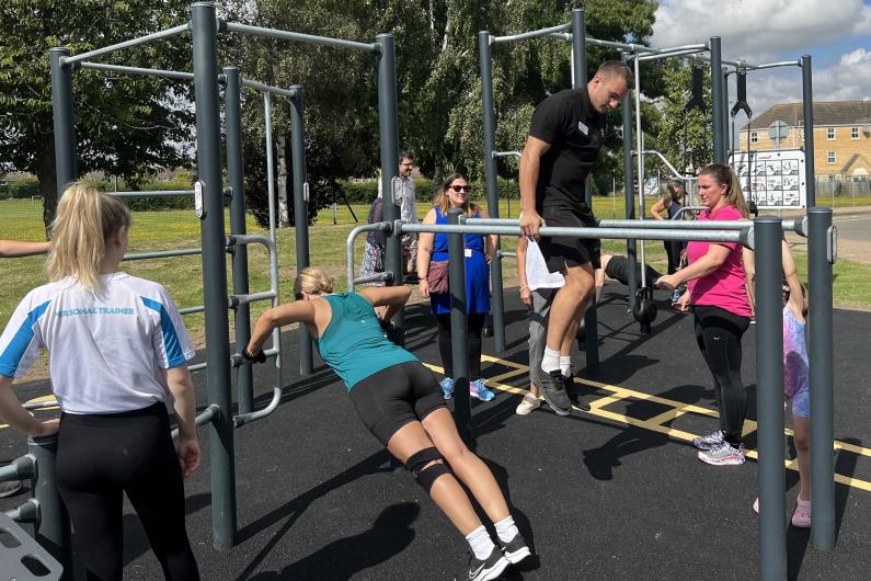 People using the new outdoor gym equipment