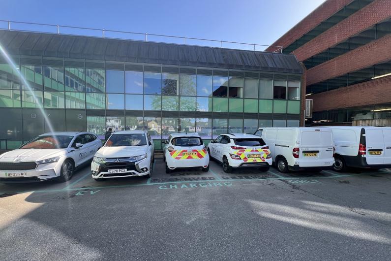 Six council electric vehicles plugged in at the council's staff car park